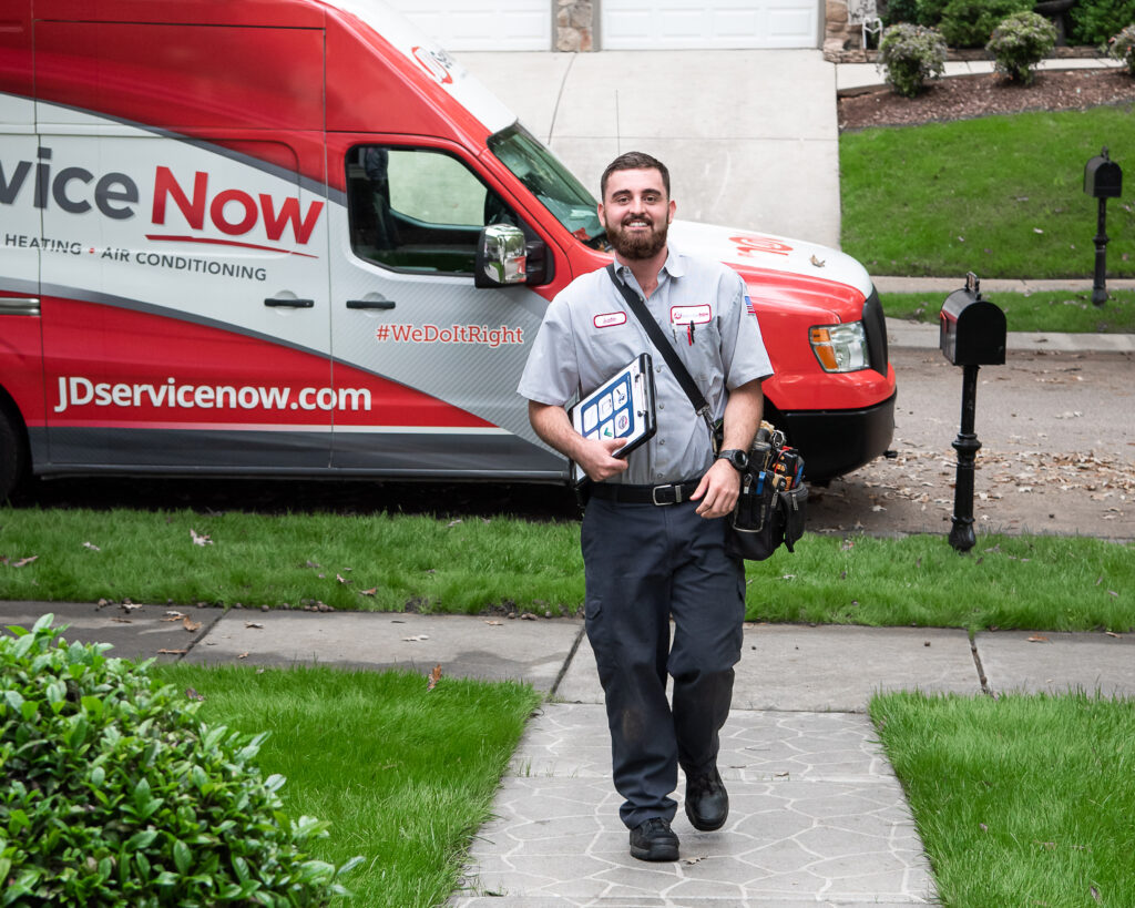 jd service now employee walking up to home with truck in background